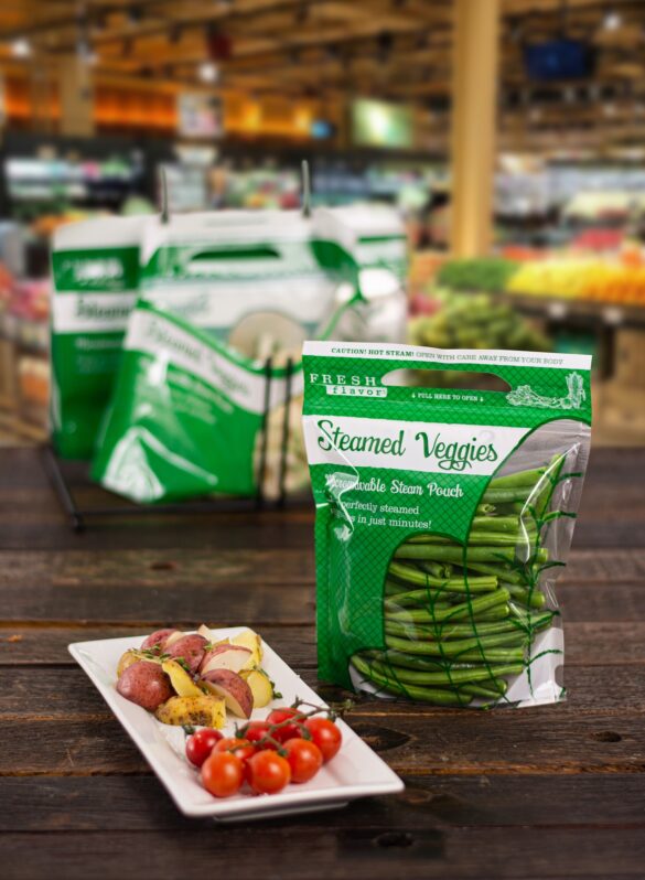 A Steam Pouch containing vegetables sits on a table in a grocery supermarket.