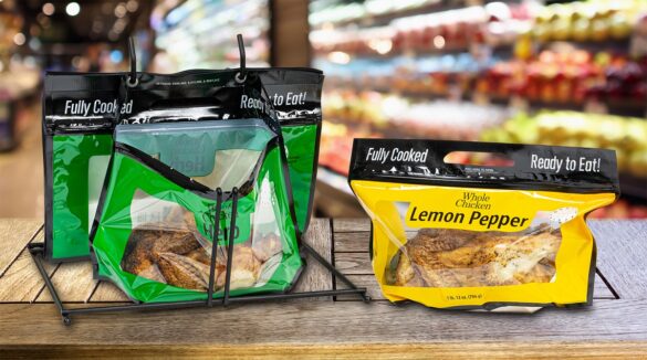 Two United Supermarkets Rotisserie Chicken bags sit on a table in a popular grocery store